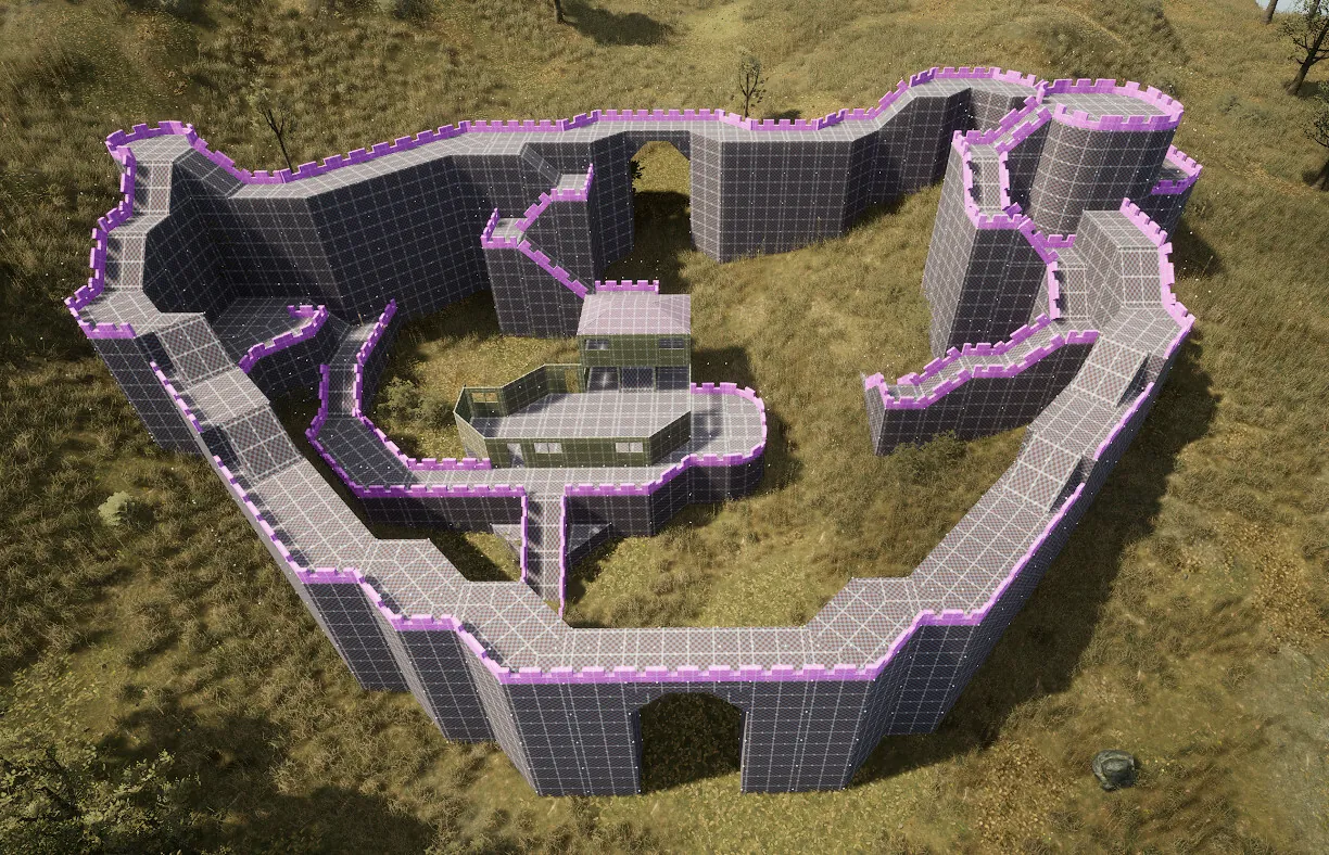 Une enceinte en cours de construction vue du ciel, ses pièces surlignées par la grille de placement