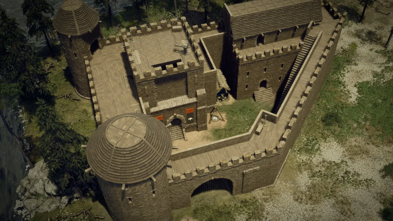 Vue aérienne d'un keep de pierre intégré à une enceinte, avec tour ronde et corps de garde